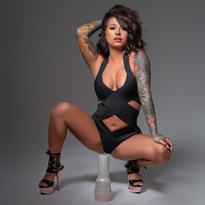 Riley Jensen crouched down with her hand on her leg and her Fleshlight positioned in front of her.